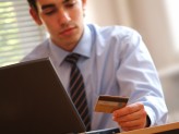 man with credit card and laptop